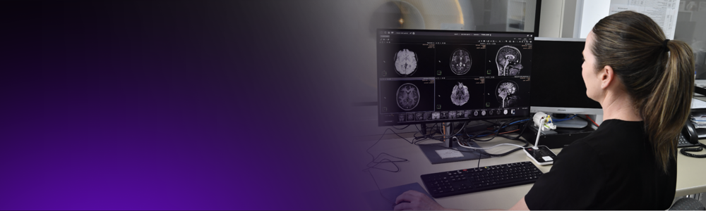 A radiographer looks at a patient scan.